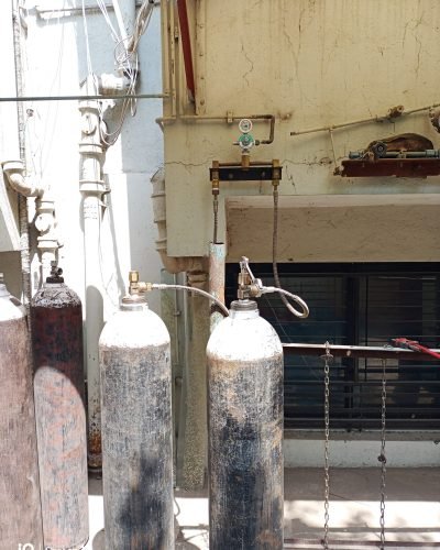 oxygen cylinders stacked in a storage area at Yadav Super Speciality Hospital